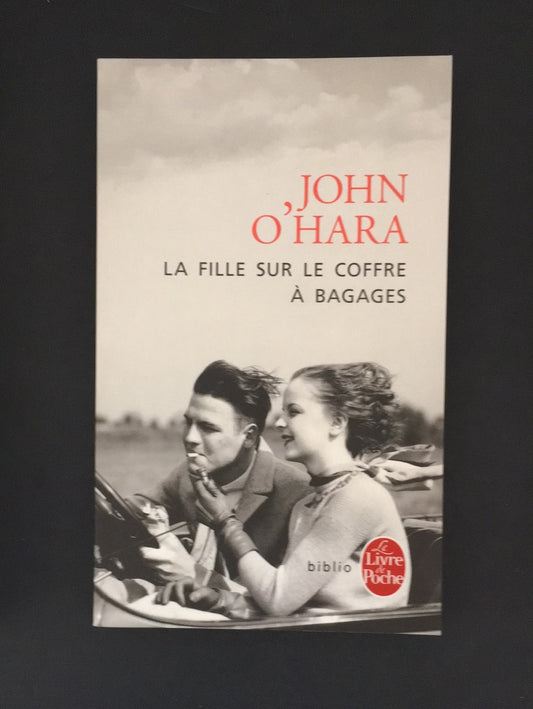 LA FILLE SUR LE COFFRE À BAGAGES.